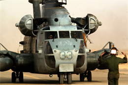 Cpl. Samuel H. Cox, a Mequon, Wis., native, directs a CH-53D Sea Stallion into a parking spot on the flight line at Al Asad, Iraq, March 21. Cox is a helicopter mechanic with Marine Heavy Helicopter Squadron 463, Marine Aircraft Group 16 (Reinforced), 3rd Marine Aircraft Wing.