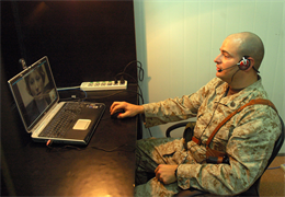 Staff Sgt. Andrew J. Kozain talks to his wife Justine, at Al Asad, Iraq, March 4, during a video teleconferencing phone call. The VTC allowed families to talk with their loved ones for 30 minutes each. For many, it was the first time they were able to see their loved ones in weeks. Kozain is currently assigned to Tactical Air Command Center Security Detachment, Echo Company, 1st Battalion, 109th Mechanized Infantry, Marine Wing Support Group 37, 3rd Marine Aircraft Wing.