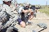 Ron Danielson, a Vietnam veteran who served with the 1st Eng. Bn., right, fires an M-4 rifle from the kneeling position Sept. 13 at Range One. Spc. Adam Williams, combat engineer, 41st Sapper Company, 1st Eng. Bn., left, acted as a coach as Danielson fired the weapon.