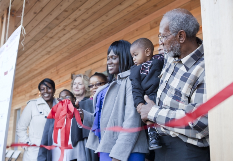 One of the new homeowners, Layika Culley, and her family cut the ribbon to her new ultra-efficient home in the historic Deanwood neighborhood. For more photos of the Empowerhouse ribbon cutting, <a href="/node/580963">view our photo gallery</a>. | Photo courtesy of Sarah Gerrity, Energy Department.