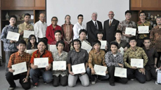 Chairman Tom Healy (back row, fourth from right) joins Fulbright Senior Scholar and IT instructor Ronnie Ward (far right) in an award ceremony for students receiving certificates of professional development in global software development.