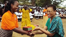 Dr. Shelby Lewis (right) receives a gift from Dr. Edith Kabonesa of Makerere University during her visit to Tororo Girls School on February 26, 2012. Dr. Lewis was one of the school’s founding teachers as a Fulbright scholar in 1965.