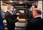 President George W. Bush views a hybrid vehicle powered by Lithium-ion batteries during a tour by Johnson Controls' CEO John Barth, far right, and employee Mike Andrew at the Johnson Controls' Battery Technology Center in Glendale, Wisconsin, Monday, Feb. 20, 2006. White House photo by Eric Draper