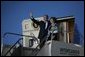 President George W. Bush and Laura Bush wave from Air Force One after landing Thursday, Nov. 3, 2005, in Mar del Plata, Argentina, where the President will participate in the Summit of the Americas.  White House photo by Krisanne Johnson