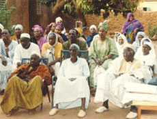 Photo of mutual health organization (MHO) meeting participants outdoors.