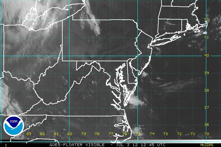 A recent visible image from GOES-12, zoomed in over a tropical disturbance.  Click on the image for a larger view.