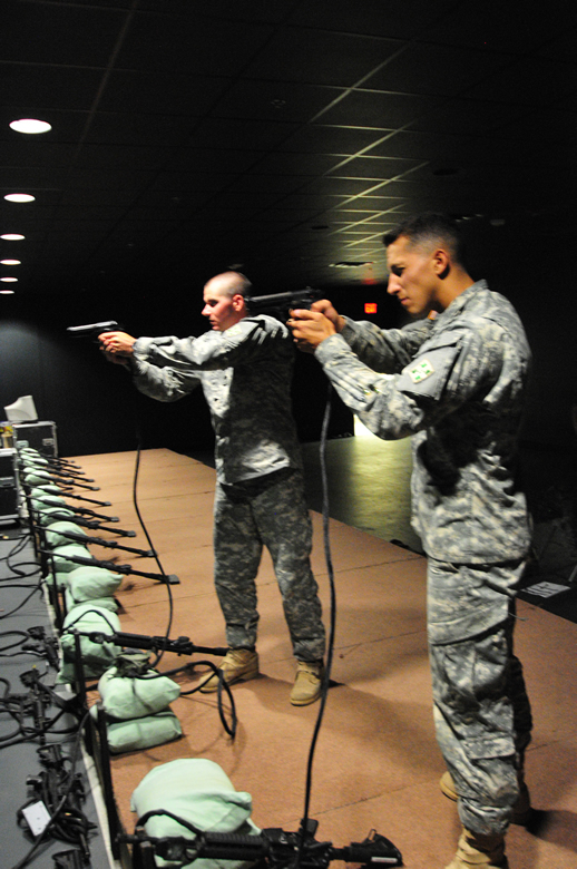 Two soldiers firing at simulated targets