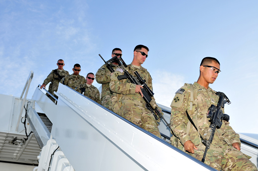 Soldiers exiting an airplane