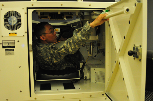 Soldier entering an M1A2 Abrams Tank Simulator