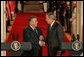 President George W. Bush shakes hands with President Jalal Talabani of Iraq after their joint press availability Tuesday, Sept. 13, 2005, in the East Room of the White House.  White House photo by Shealah Craighead