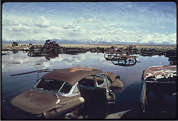 “Abandoned automobiles and other debris clutter an acid water and oil filled five acre pond. It was cleaned up under EPA supervision to prevent possible contamination of Great Salt Lake and a wildlife refuge nearby. Bruce McAllister for Documerica