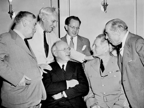 Minister Hurley (seated, at right) enjoying a moment with Prime Minister Peter Fraser (seated, at left) and Minister Nash (at left).
