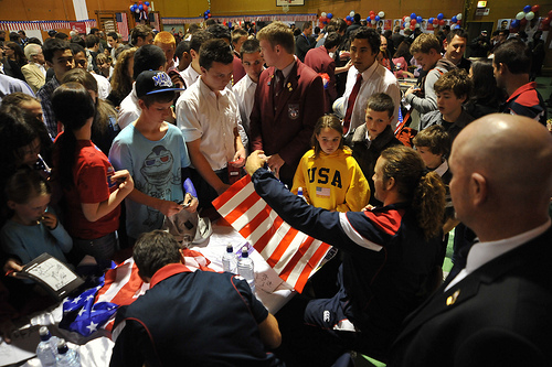 Todd Clever signing the US flag for fans.