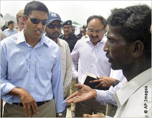 Rajiv Shah talking with Pakistani flood survivor (AP Images)