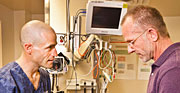 Albuquerque emergency room physician Scott Forman, left, and Sandia engineer Mark Reece look over a prototype set of improved trauma shears they worked on together. (Photo by Randy Montoya)