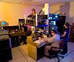 Curtis Brown, Thomas LaGrange and Judy Kim make adjustments to the dynamic transmission electron microscope.