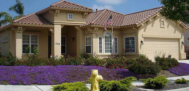 Image of a house with trees and flowers