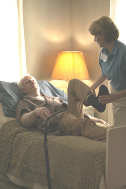 nurse bends man's leg