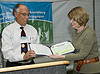 George Rael presenting a bronze award for "green" purchasing to Laboratory Deputy Director Beth Sellers.