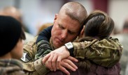 A soldier assigned to the South Carolina National Guard’s 3/49 Agribusiness Development embraces a family member after the unit's departure ceremony on McCrady Training Center, S.C., Jan. 10, 2013. The 3/49 ADT is departing to Camp Atterbury, Ind., for training before their deployment to Afghanistan where they will teach local farmers agricultural techniques to improve their lives and provide for their families. National Guard photo by Staff Sgt. Jorge Intriago