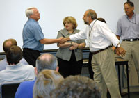 USGS National Wetlands Research Center Director Gregory Smith shakes hands with Larry Handley