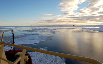 Photo of the Swedish Oden on the horizon steaming to meet NSF's Nathaniel B. Palmer.