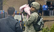 A soldier holds a child displaced by Hurricane Sandy in Hoboken, N.J., Oct. 31, 2012. The soldier is assigned to the New Jersey National Guard. U.S. Army photo by Spc. Joseph Davis