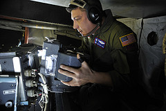 Film magazine maintenance during OC-135B mission over Haiti.