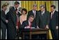 President George W. Bush signs the Trade Act of 2002 in the East Room Tuesday, Aug. 6. "With trade promotion authority, the trade agreements I negotiate will have an up-or-down vote in Congress, giving other countries the confidence to negotiate with us," said the President in his remarks.  