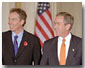 President George W. Bush and Prime Minister Tony Blair of England walk out to address the media in Cross Hall at the White House Nov. 7. "We've got no better friend in the world than Great Britain," said the President during his remarks. White House photo by Paul Morse.