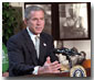 Urging Americans to give of themselves during this holiday season, President George W. Bush addresses volunteers and media at So Others Might Eat interfaith charity in Washington, D. C., Nov. 20. Preparing breakfast and lunch, the programs serves more than 300,000 meals to homeless each year. White House photo by Tina Hager.