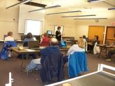 Image: A staff member teaches visitors Internet security tips