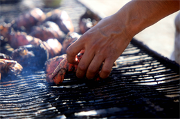 Staff Sgt. Juan Contreras, a senior advisor with the food service contact team, I Marine Expeditionary Force Headquarters Group (Forward), cooks lobster for Marines and sailors at Combat Outpost Fiddlers Green, Sept. 27. Contreras, from Santa Ana, Calif., is currently serving on his fifth combat deployment.