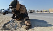 Photo: BAHRAIN (Nov. 12, 2012) Lt. j.g. Michael Aragon, assigned to Explosive Ordnance Disposal Mobile Unit (EODMU) 11, removes blasting caps from detonation cord while dressed in a bomb suit during a training exercise. EODMU-11 is deployed with Commander, Task Group 56.9, which provides maritime security operations and theater security cooperation efforts in the U.S. 5th Fleet area of responsibility. AmericaÕs Sailors are Warfighters, a fast and flexible force deployed worldwide. Join the conversation on social media using #warfighting. (U.S. Navy photo by Mass Communication Specialist 2nd Class Derek R. Sanchez/Released)