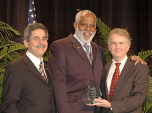 Joseph, center, stands with Legal Aid Bureau Board President Warren Oliveri, right, and Jos Padilla, NLADA Board President and executive director of California Rural Legal Assistance.