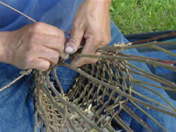 man weaving a basket.