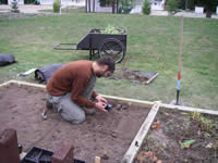 Dan McConnell transplanting native plants into the pollinator interpretive garden.