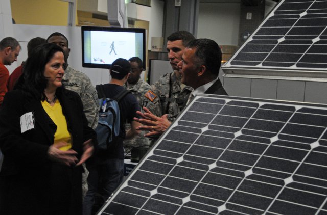 Katherine Hammack, assistant secretary of the Army for Installations, Energy and Environment, stands just to the left of a Rapid Equipping Force-procured solar panel system used by Soldiers in Afghanistan and also during a Network Integration Evaluation 13.1 in November at the White Sands Missile Range, N.M. The venue is the Washington Auto Show in February 2013, in the nation's capital.