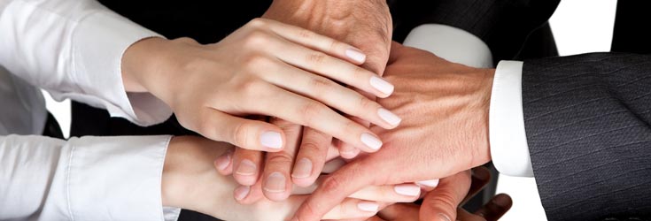 A photo of many hands placed above each other.