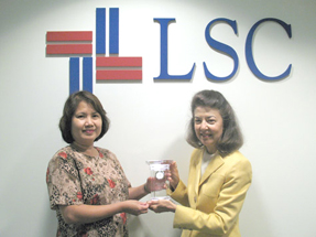 Charito Villa, left, receives service award from LSC President Helaine M. Barnett