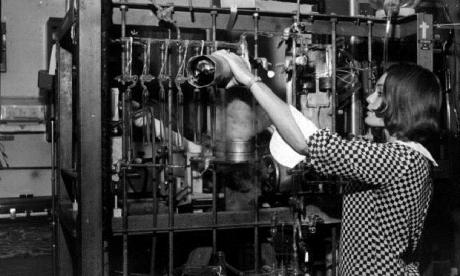 Unidentified woman working with scientific equipment.