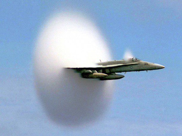 A cloud forms as this F/A-18 Hornet aircraft speeds up to supersonic speed. Aircraft flying this fast push air up to the very limits of its speed, forming what's called a bow shock in front of them. (Photo: Ensign John Gay, USS Constellation, U.S. Navy)