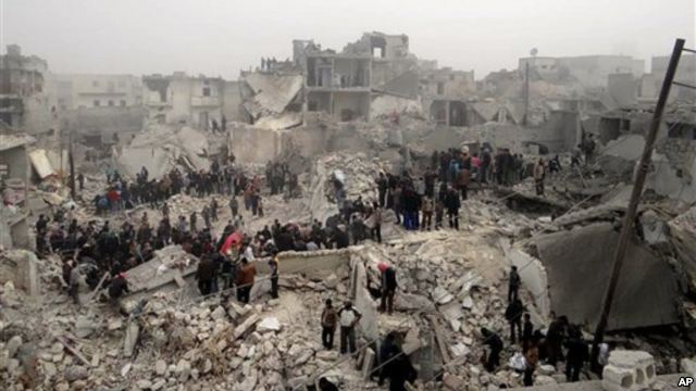 This citizen journalism image from the Aleppo Media Center (AMC) shows people searching debris of destroyed buildings after Syrian government forces airstrike, Jabal Bedro, Aleppo, Feb. 19, 2013.