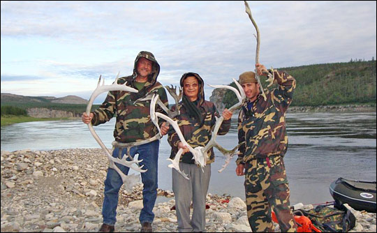 Photograph of Ross Nelson, Guoqing Sun, and Paul Montesano holding reindeer antlers.