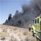 Fire crews and a fire truck working on a local wildfire