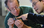 engineers examine wireless sensing device