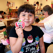 Girl smiling and holding her name tag