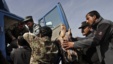 Afghan soldiers remove dead passenger from  truck after U.S. forces shot two passengers and injured another on road between Kabul and Bagram, March 11, 2013.