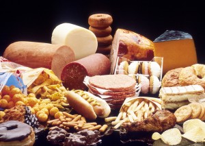 A display of high fat foods such as cheeses, chocolates, lunch meat, french fries, pastries, doughnuts, etc. (Photo: US National Cancer Institute)