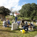 Participants clean marble headstone during the December workshop.